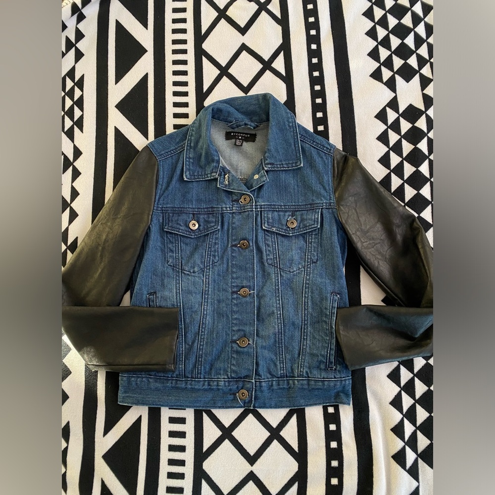 Dark denim jean jacket with faux leather sleeves